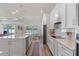 Open kitchen features stainless steel appliances, stone countertops, an island, and a dining area at 4131 Sunset Preserve Blvd, Orlando, FL 32820