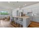 Modern kitchen with stainless steel appliances, large island, barstool seating, and pendant lighting at 4131 Sunset Preserve Blvd, Orlando, FL 32820