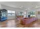 Bright living room with vinyl floors, a large pink couch, and large windows and sliding doors at 4131 Sunset Preserve Blvd, Orlando, FL 32820