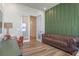 Well-lit living room with study space, modern decor, and sliding glass door access at 4131 Sunset Preserve Blvd, Orlando, FL 32820
