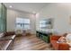 Open concept living room with sleek furnishings, entertainment center, and laminate flooring at 4131 Sunset Preserve Blvd, Orlando, FL 32820