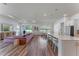 Open concept living room with view of kitchen, dining, and sliding doors to the backyard at 4131 Sunset Preserve Blvd, Orlando, FL 32820