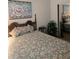 Charming bedroom with floral bedding, wooden bed frame, and a mirrored closet providing a sense of spaciousness at 5008 Sawgrass Lake Cir, Leesburg, FL 34748
