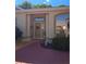 Close-up of front entrance featuring a decorated front door, lovely shrubbery, and pink brick walkway at 5008 Sawgrass Lake Cir, Leesburg, FL 34748