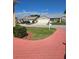 Neighborhood street showcasing well-maintained lawns and charming home exteriors at 5008 Sawgrass Lake Cir, Leesburg, FL 34748