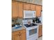Well-equipped kitchen featuring wooden cabinets, modern appliances, and a countertop with ample workspace at 5008 Sawgrass Lake Cir, Leesburg, FL 34748