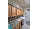 Functional laundry room featuring ample cabinet space, a sink, modern washer and dryer, and a convenient layout at 5008 Sawgrass Lake Cir, Leesburg, FL 34748