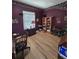 Home office featuring wood floors, a bookshelf, and a comfortable chair at 5008 Sawgrass Lake Cir, Leesburg, FL 34748