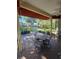 Relaxing screened-in patio with ceiling fan and comfortable outdoor seating at 5008 Sawgrass Lake Cir, Leesburg, FL 34748