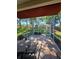 Cozy screened patio complete with brick flooring, seating area, and beautiful views of the expansive backyard at 5008 Sawgrass Lake Cir, Leesburg, FL 34748
