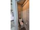 Charming powder room with decorative wallpaper and vanity with framed seashells at 5008 Sawgrass Lake Cir, Leesburg, FL 34748