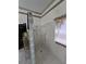 Spacious tiled shower with glass block and accessibility handrail at 5008 Sawgrass Lake Cir, Leesburg, FL 34748