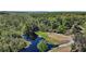 Aerial view of the property featuring a boat on the canal at 5331 Magnolia Ridge Rd, Fruitland Park, FL 34731