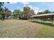Expansive backyard featuring a covered boat slip and lush green lawn, perfect for outdoor activities at 5331 Magnolia Ridge Rd, Fruitland Park, FL 34731