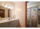 The bathroom has an updated vanity, new lighting, and a shower and tub combination at 5331 Magnolia Ridge Rd, Fruitland Park, FL 34731