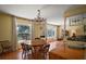 Open concept dining room featuring chandelier, wood flooring and view to living room at 5331 Magnolia Ridge Rd, Fruitland Park, FL 34731