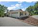 Side exterior featuring a spacious driveway and well-manicured garden at 5331 Magnolia Ridge Rd, Fruitland Park, FL 34731