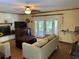 Open living area with a brick fireplace and doors to the outdoor patio space at 5331 Magnolia Ridge Rd, Fruitland Park, FL 34731