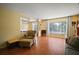 Spacious living room with hardwood floors, natural light and view to dining room at 5331 Magnolia Ridge Rd, Fruitland Park, FL 34731