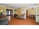 Open-concept living room with hardwood floors, large windows and comfortable furnishings at 5331 Magnolia Ridge Rd, Fruitland Park, FL 34731