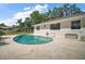 Relaxing Kidney-shaped pool with a light concrete deck perfect for enjoying the outdoors at 5331 Magnolia Ridge Rd, Fruitland Park, FL 34731