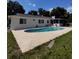 Backyard featuring a lovely kidney-shaped pool with an expansive deck, great for entertaining at 5331 Magnolia Ridge Rd, Fruitland Park, FL 34731