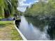 Scenic view of the canal, featuring lush greenery and a small dock, perfect for waterfront enjoyment at 5331 Magnolia Ridge Rd, Fruitland Park, FL 34731