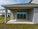 View of covered patio with sliding glass doors and concrete flooring, perfect for outdoor living at 5457 Marshelder St, Apopka, FL 32712