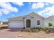 Charming single-story home with a two-car garage, brick driveway, and inviting front entrance at 5511 Nickerbean St, Apopka, FL 32712