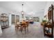Bright dining area leading to a comfortable living space with hardwood floors at 5549 Millican Ave, The Villages, FL 32163