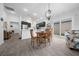 Open-concept space with a dining area and kitchen featuring a breakfast bar at 5549 Millican Ave, The Villages, FL 32163