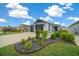 Beautiful home showcasing lush landscaping and a well-manicured lawn at 5549 Millican Ave, The Villages, FL 32163