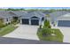 Charming home features a well-maintained front yard, a two-car garage, and excellent curb appeal at 5549 Millican Ave, The Villages, FL 32163