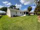 Backyard view highlighting the screened-in lanai and well-maintained lawn, perfect for outdoor enjoyment at 664 San Pedro Dr, The Villages, FL 32159