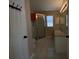 Bathroom with a tiled floor, corner glass shower, neutral colored walls, and a light fixture at 664 San Pedro Dr, The Villages, FL 32159