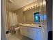 Well-lit bathroom featuring a shower/tub combo and a white vanity with ample storage space at 664 San Pedro Dr, The Villages, FL 32159