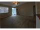 Spacious living room with neutral carpet and ample natural light from the front door and window at 664 San Pedro Dr, The Villages, FL 32159