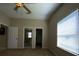 Bright bedroom with vaulted ceiling featuring a ceiling fan and view to bathroom and walk-in closet at 664 San Pedro Dr, The Villages, FL 32159
