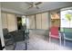 Relaxing sun room with tile floors, ceiling fan, and multiple windows offering scenic views at 664 San Pedro Dr, The Villages, FL 32159