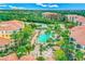 Aerial view of community amenities, showcasing a large pool, lush landscaping, and resort style buildings at 8801 Worldquest Blvd # 4203, Orlando, FL 32821