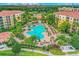 Aerial community shot showcasing a large pool, landscaping, and multiple resort-style buildings at 8801 Worldquest Blvd # 4203, Orlando, FL 32821
