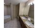 Bathroom featuring double vanity sinks, soaking tub, and granite countertops at 8801 Worldquest Blvd # 4203, Orlando, FL 32821