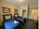 A cozy bedroom featuring twin beds, soft lighting, and ample storage space at 8801 Worldquest Blvd # 4203, Orlando, FL 32821
