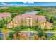 Exterior view of the multi-story building featuring private balconies and landscaping at 8801 Worldquest Blvd # 4203, Orlando, FL 32821