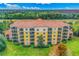 Aerial view of the multi-story building featuring private balconies and a lush landscape at 8801 Worldquest Blvd # 4203, Orlando, FL 32821