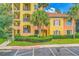 Exterior view of the building featuring private balconies, awnings, and mature landscaping at 8801 Worldquest Blvd # 4203, Orlando, FL 32821