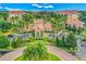 View of the community clubhouse showing circular driveway with landscaping and ample parking at 8801 Worldquest Blvd # 4203, Orlando, FL 32821