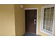 Condominium front door, showing electronic lock and large picture window at 8801 Worldquest Blvd # 4203, Orlando, FL 32821