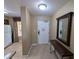 Hallway featuring mirror and table, leading to kitchen with white refrigerator at 8801 Worldquest Blvd # 4203, Orlando, FL 32821