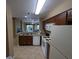 Bright open kitchen with granite countertops, tile floor, and stainless steel sink at 8801 Worldquest Blvd # 4203, Orlando, FL 32821